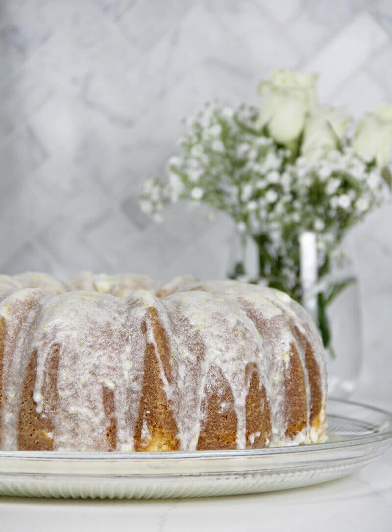 Easy Lemon Pound Cake with Lemon Glaze is a simple recipe using the Cream Cheese Pound Cake base and adding a zesty lemony glaze—it's fresh, pretty, and lip-smacking good!