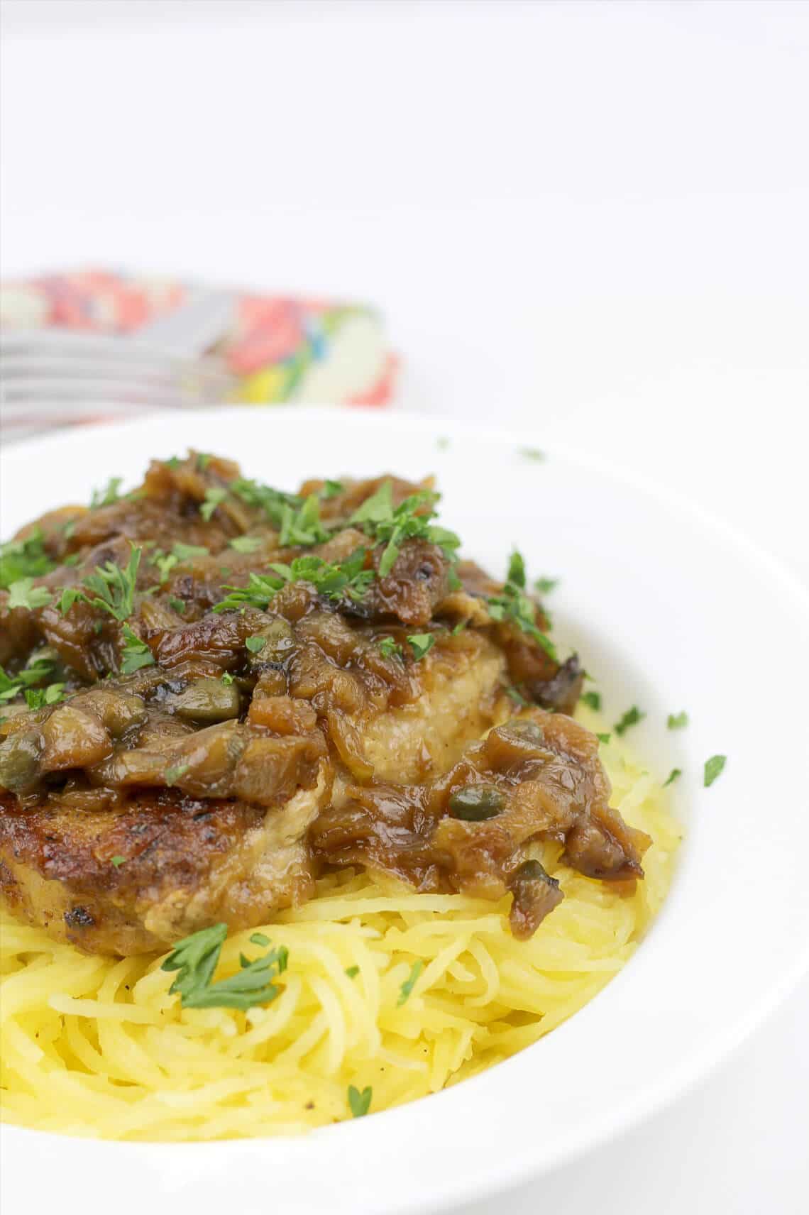 Pork chops with caramelized onions, capers, and white wine are delicious with noodles, mashed potatoes, cheese grits, or spaghetti squash.