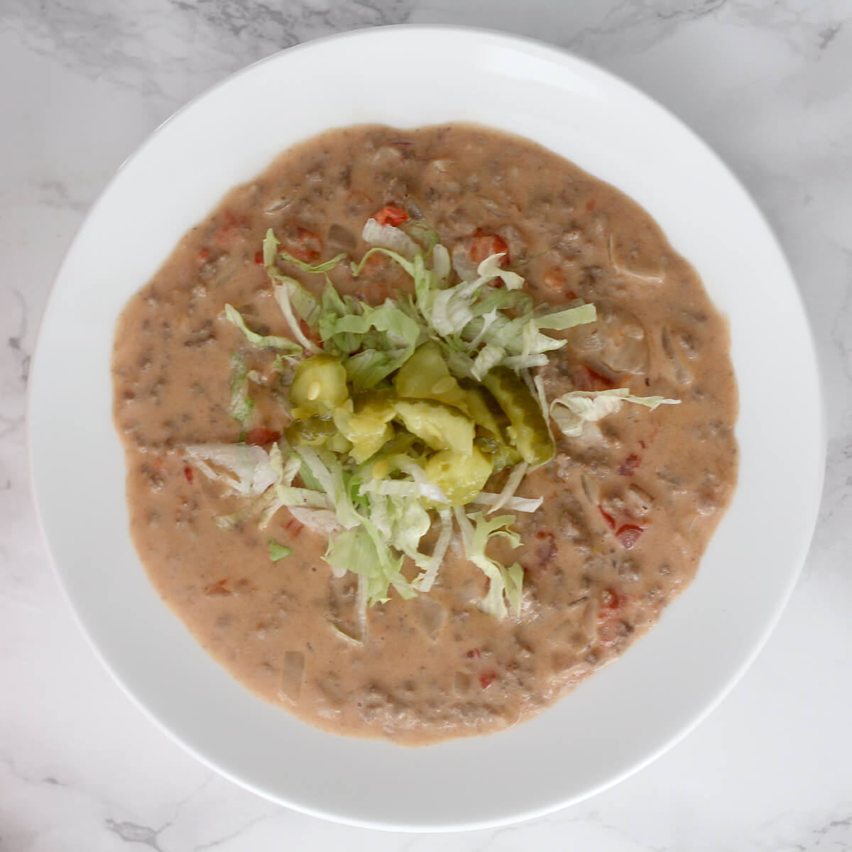 Cheeseburger Soup is everything you love in a cheeseburger—bacon, beef, cheese, onions, tomatoes, all in a creamy, luscious, easy soup!