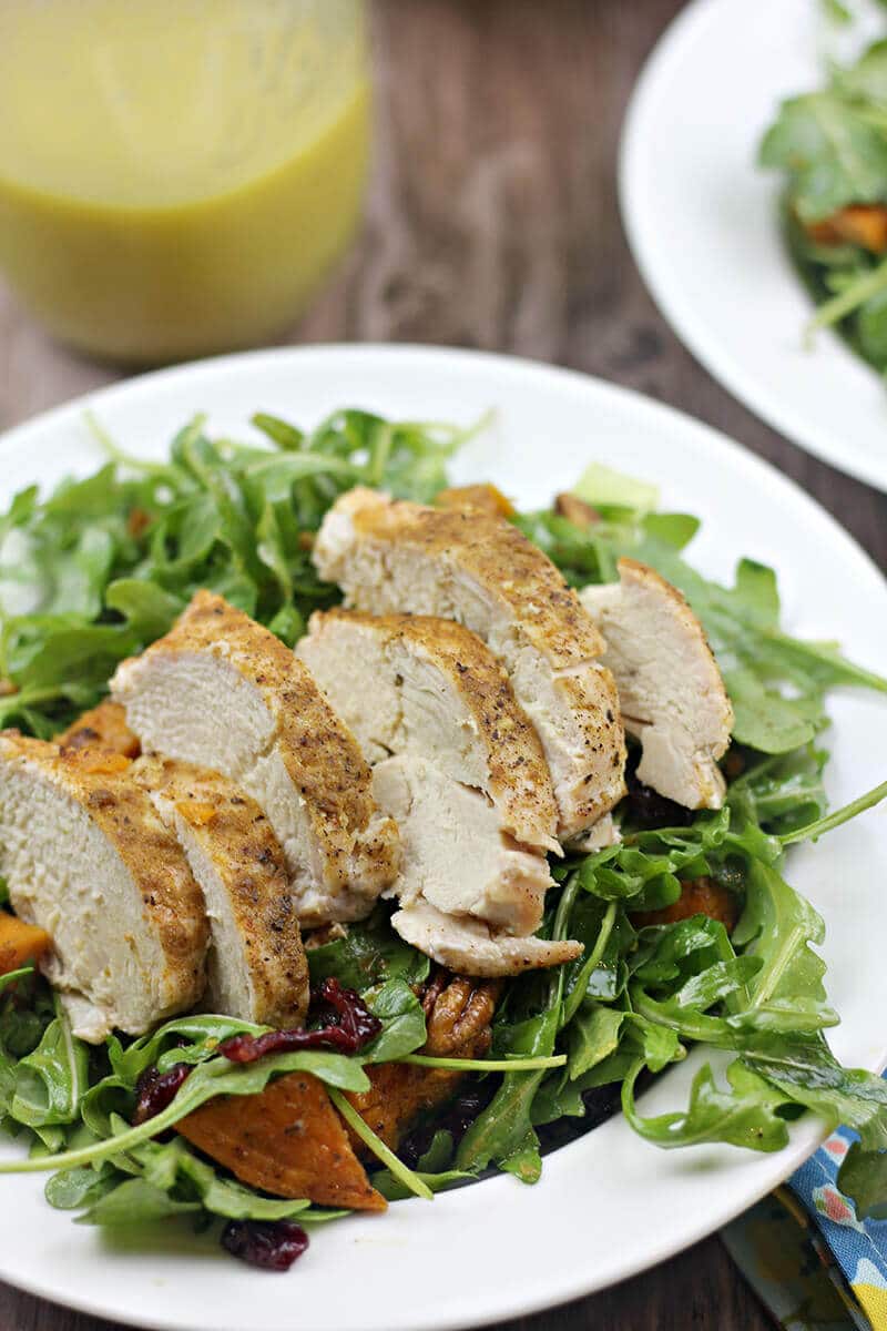 Arugula Salad with Roasted Sweet Potatoes and Chicken in salad bowl.