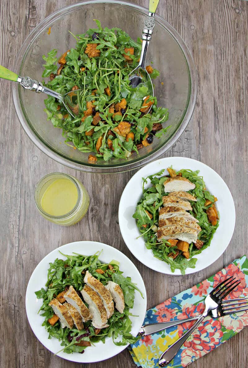 Arugula Salad with Sweet Potatoes and chicken on plates.