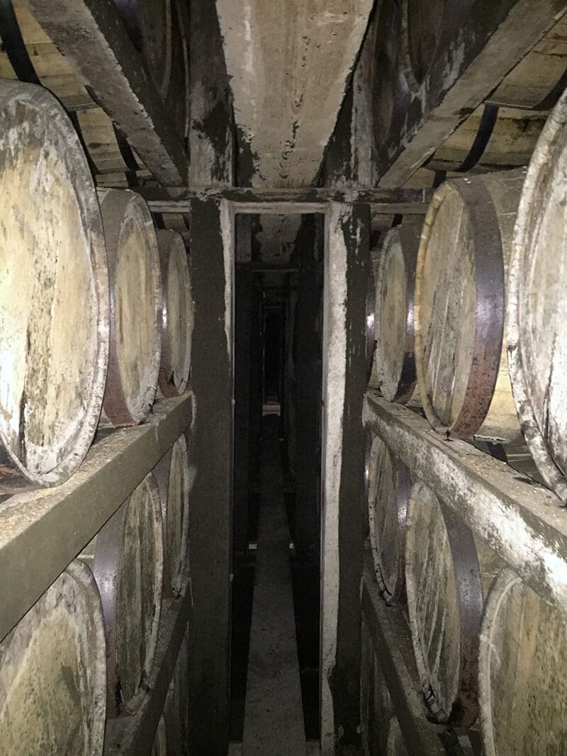 Kentucky Travel Guide showing Rows of bourbon barrels at Buffalo Trace distillery.