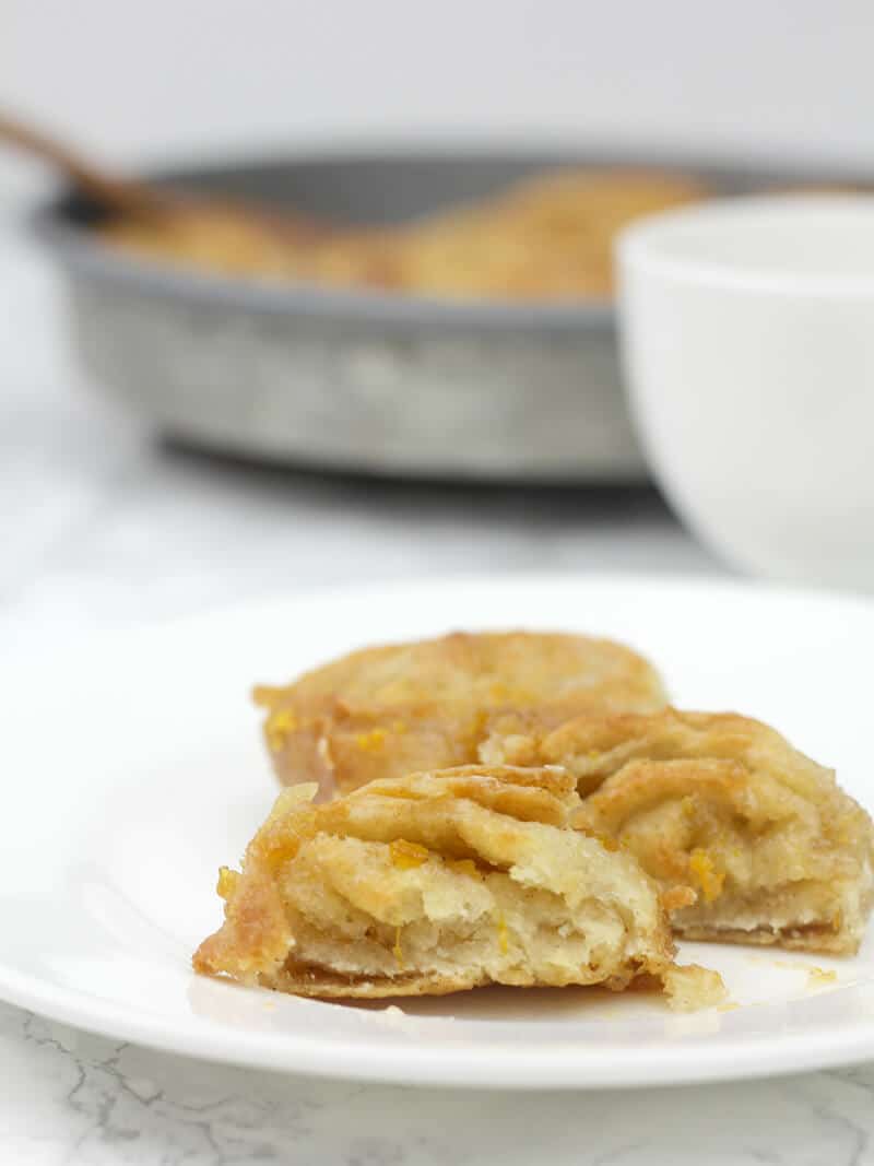 A plate of Orange rolls and cream Cheese icing.