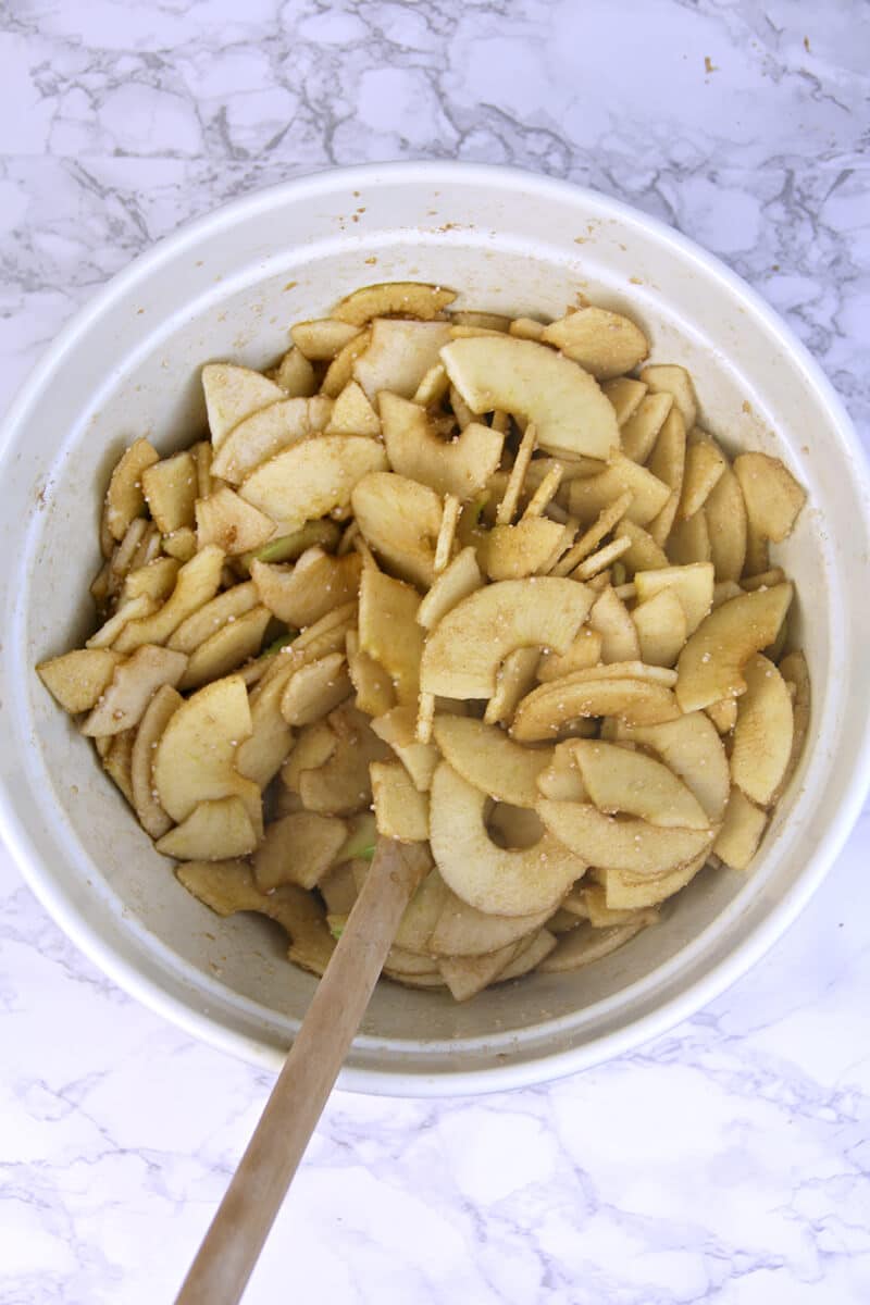 Mixing apples in bowl for Double-Crust Apple Pie.