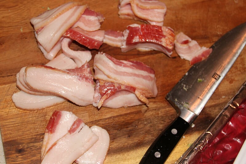 Chopped bacon on cutting board for Southern Baked Beans.