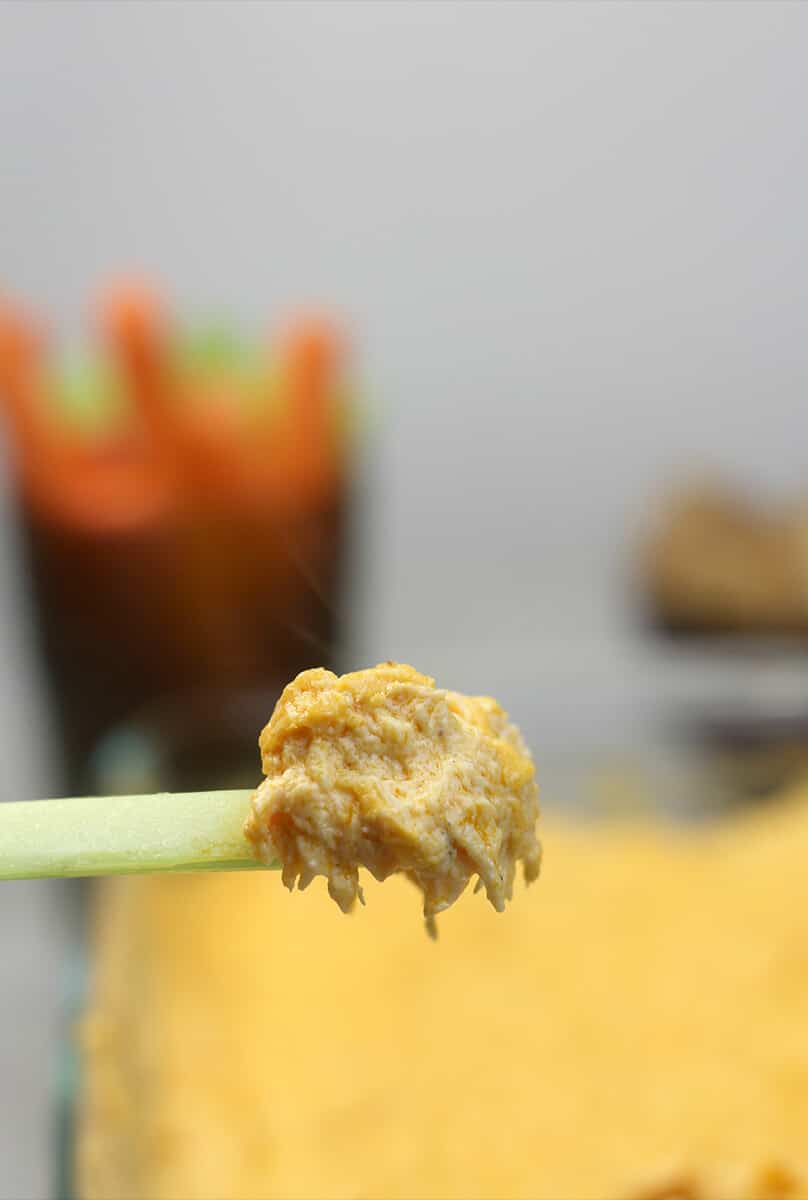 Closeup of Buffalo Chicken Dip on a piece of celery. 