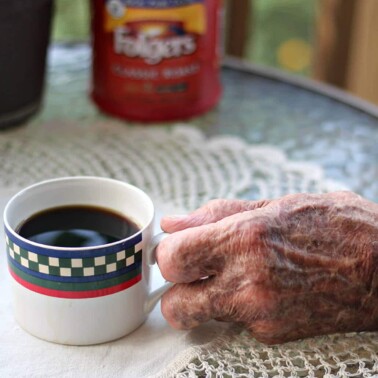 Veterans hand holding Folgers coffee.
