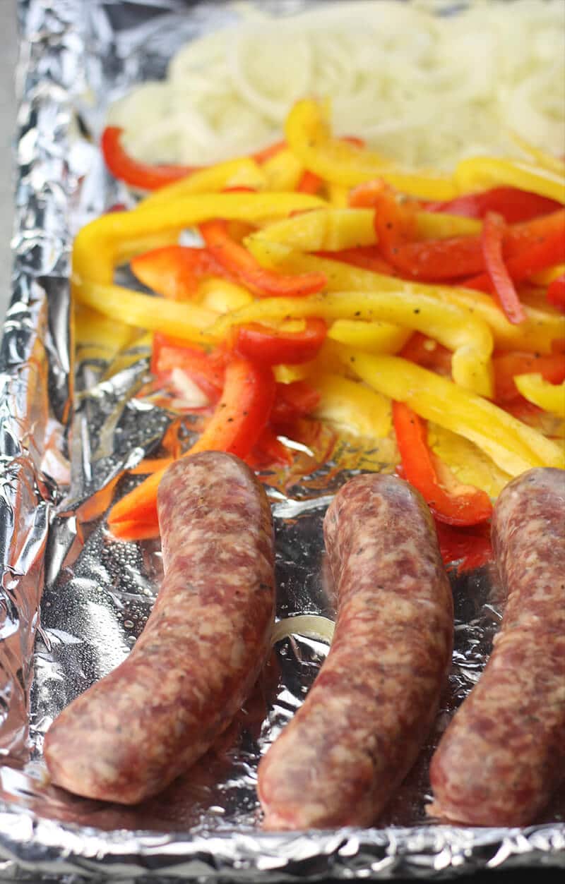 Sausage, Peppers, and Onions on a baking sheet ready to cook.