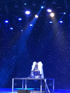 An empty chair on the stage in the show Magic Beyond Belief in Pigeon Forge.