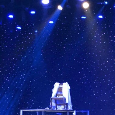 An empty chair on the stage in the show Magic Beyond Belief in Pigeon Forge.