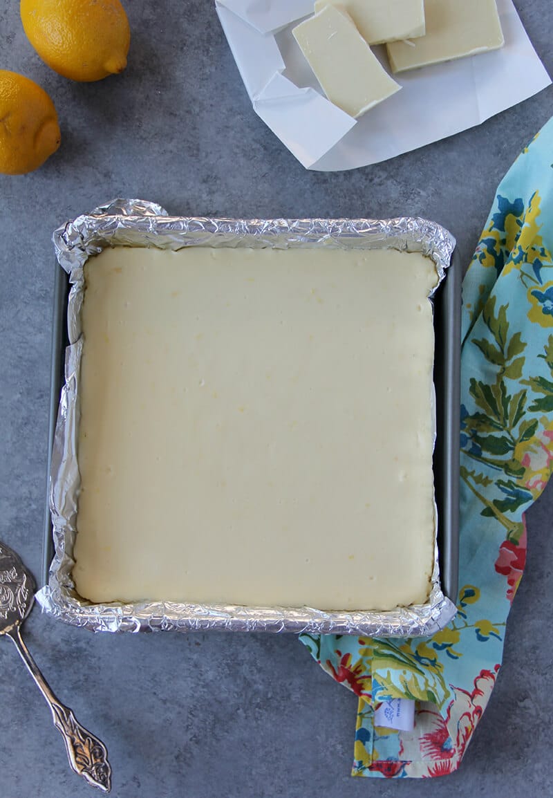White chocolate cheesecake bars cooling in the pan after baking.