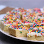 A plate of sugar cookie bars with sprinkles.
