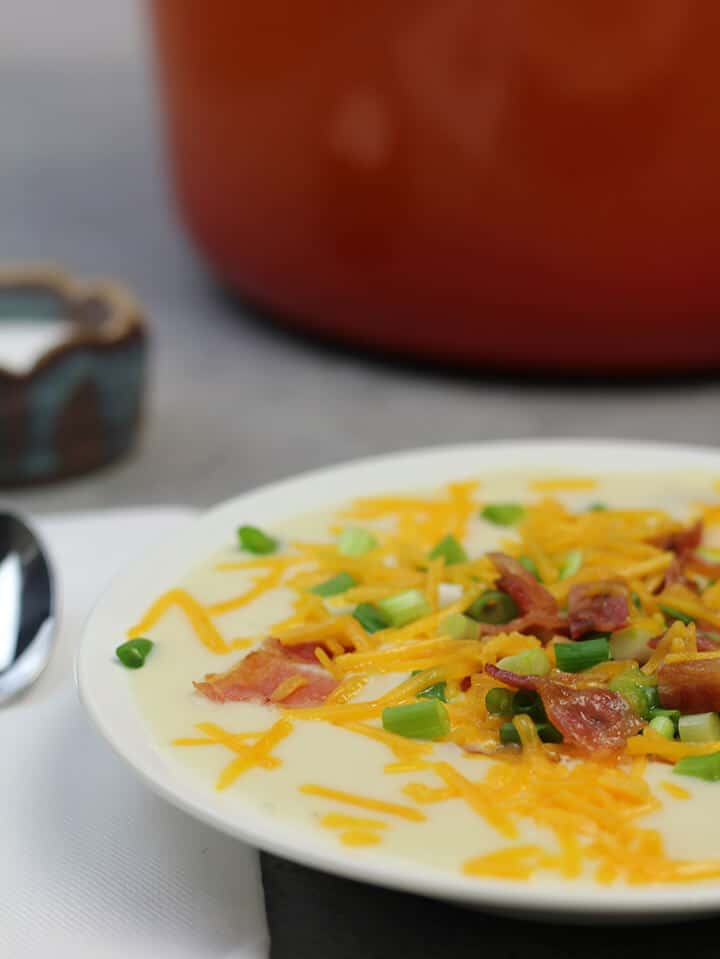 bowl of potato soup with cheese and bacon.