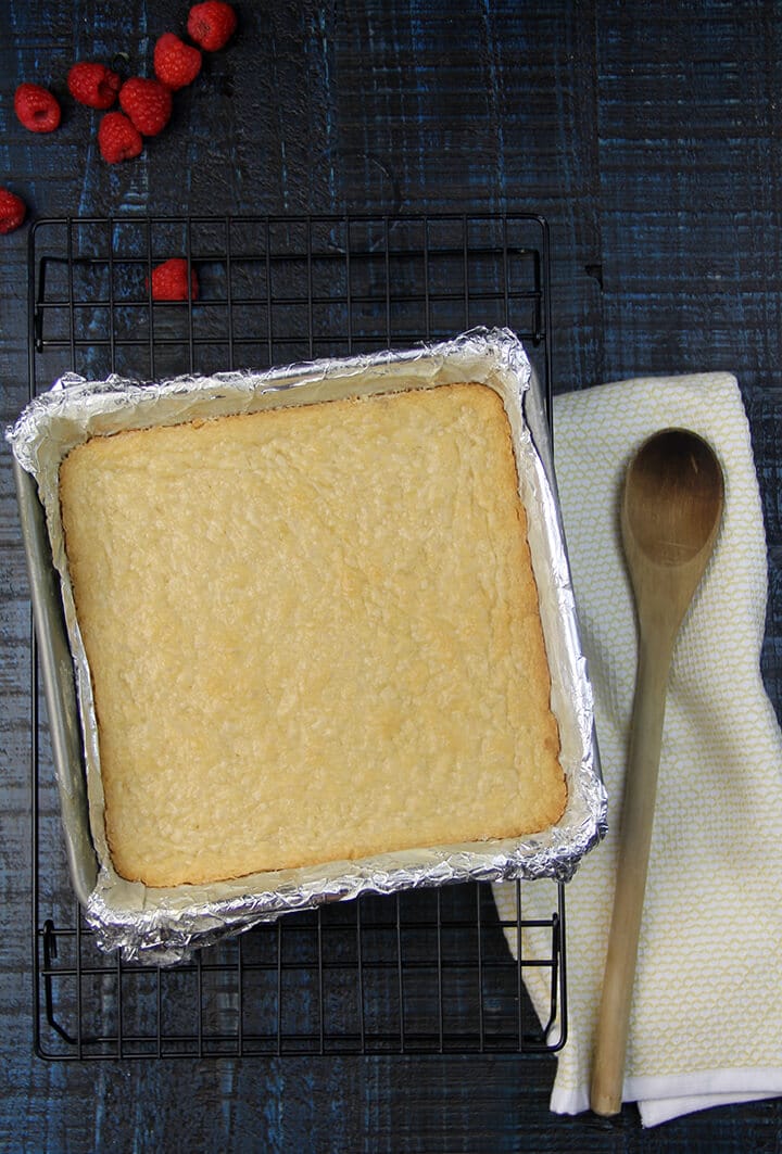 Pan of baked shortbread for making raspberry crumble bars.