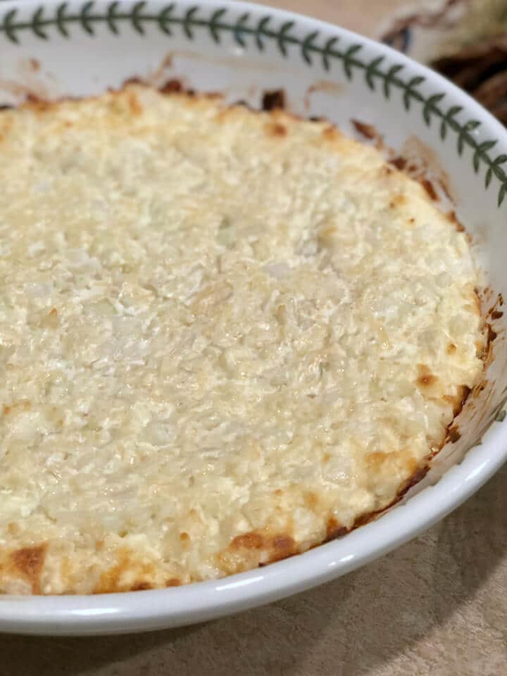 A side view of a dish of baked Vidalia onion dip.