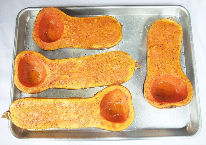 A pan of halved butternut squash for soup.