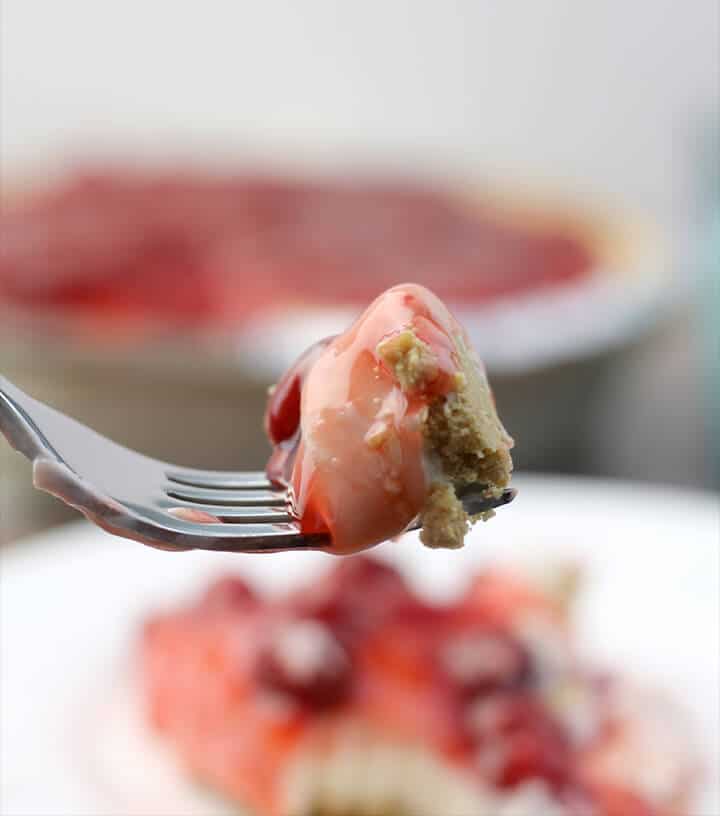 A bite of cherry cream cheese pie on a fork.