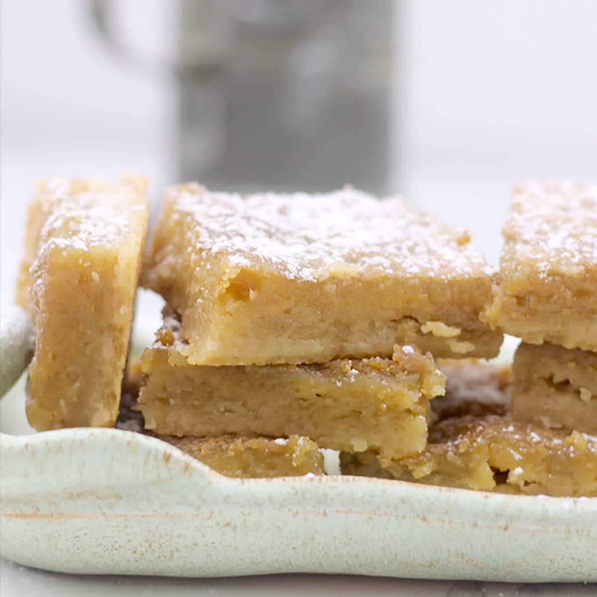 Closeup of chess pie bars on a plate.