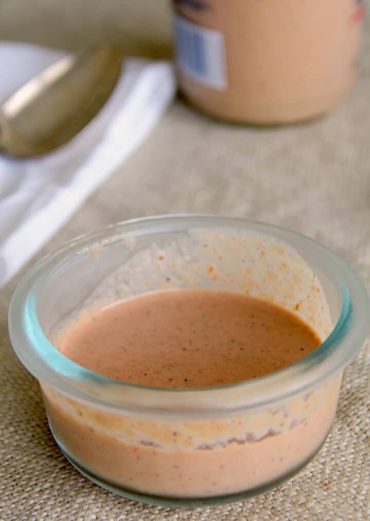 Comeback sauce in a bowl with a jar in the background.