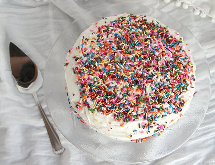 Overhead photo of a whole funfetti cake on a white background.