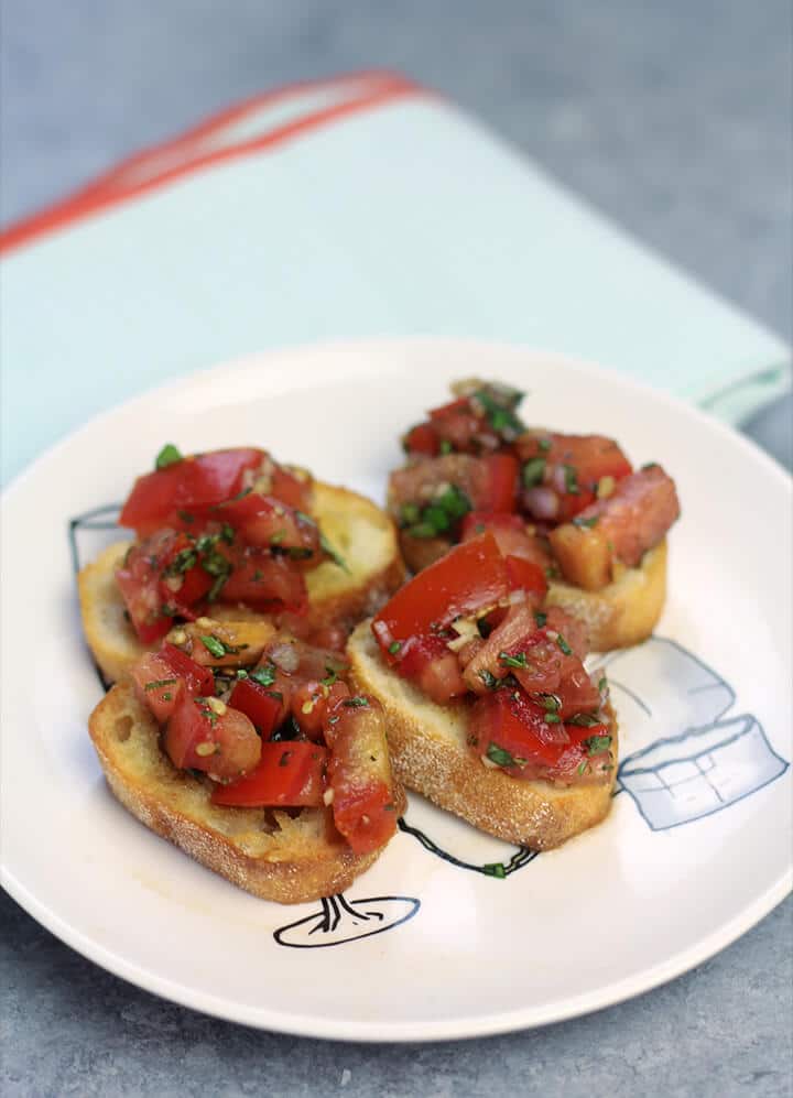 Bruschetta on toasted bread on a plate.