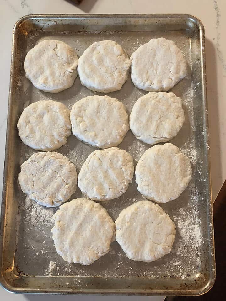 A pan of homemade biscuits flattened and ready to bake.