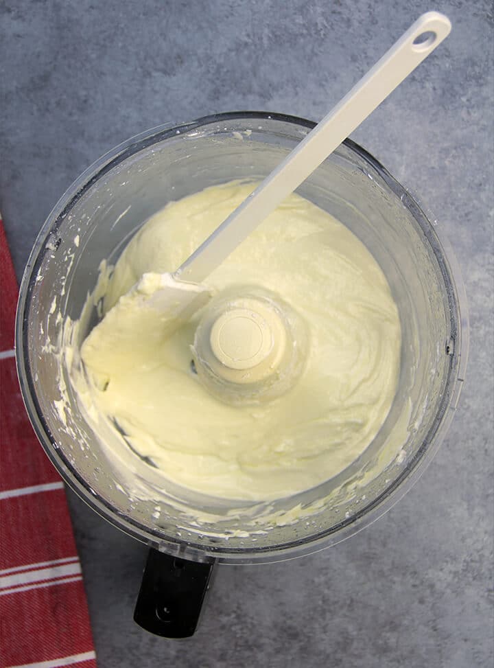 Smooth and creamy feta and cream cheese in food processor bowl.