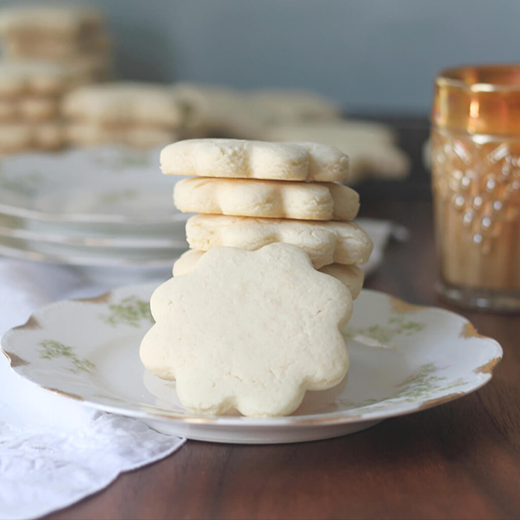 Tea cakes are buttery and slightly soft, not as sweet as a sugar cookie and falling somewhere between a cookie and a cake. They are an old-fashioned Southern favorite! This recipe is so easy--no mixer required and no chilling dough. You can have these wonderful tea cakes ready in about 30 minutes!