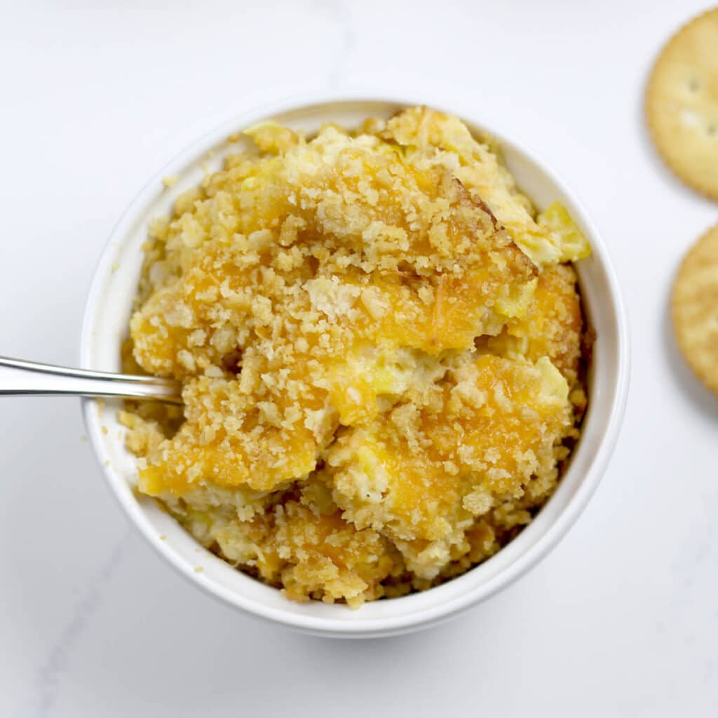 Southern Squash Casserole is a favorite at every gathering. With grated Cheddar cheese, crumbled Ritz crackers, and fresh summer squash, this squash casserole is a great way to use those summer vegetables!