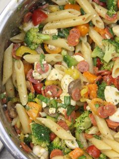 Pizza Pasta Salad with pepperoni, peppers, tomatoes, and mozzarella balls is super easy--and perfect for tailgates. Minimal chopping is required and you can mix and match ingredients.