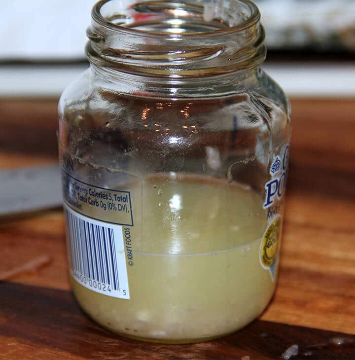 A jar filled with lemon juice to make french salad dressing.