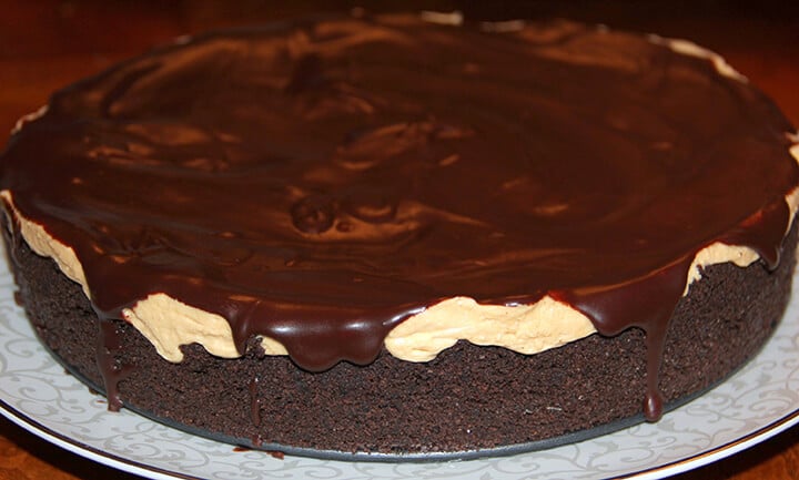A whole chocolate peanut butter pie on a serving platter.