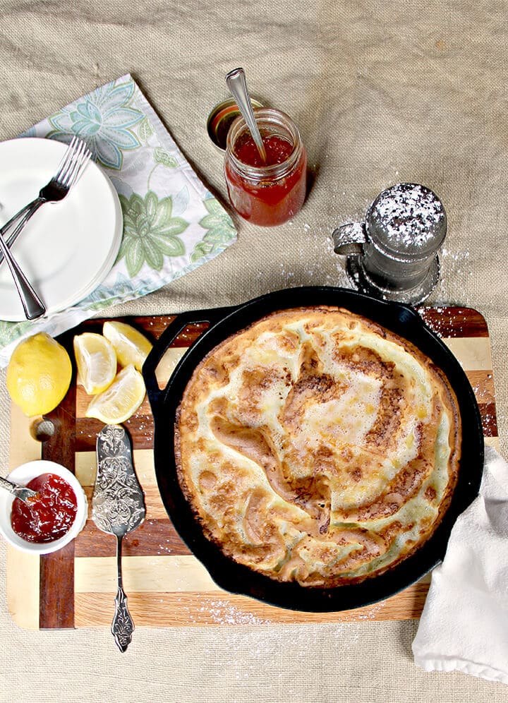 Overhead photo of a plain Dutch baby pancake in a cast iron skillet.