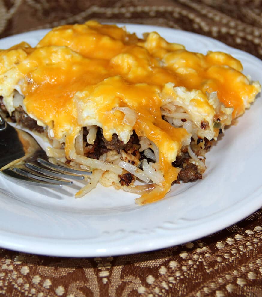 Sausage breakfast pizza with eggs and cheese over a crescent roll crust is a fun and delicious cheesy breakfast. Kids love this recipe!