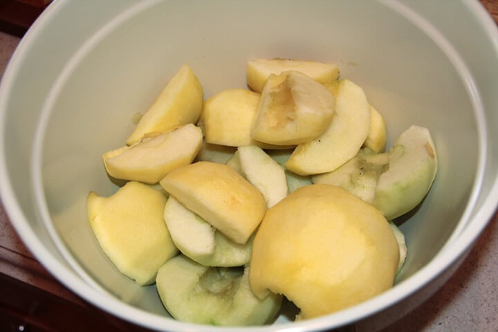 Cut and peeled apples in a bowl.