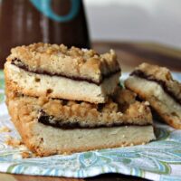 These Chocolate Caramel Shortbread Bars are decadent and delicious! They are covered in a rich nutella ganache and topped with a brown sugar streusel then a generous drizzle of salted caramel sauce.