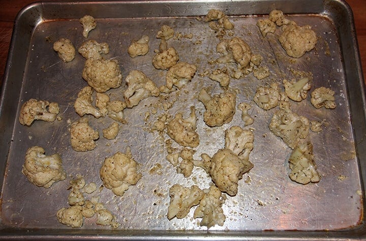 Cauliflower on a baking sheet ready to roast.