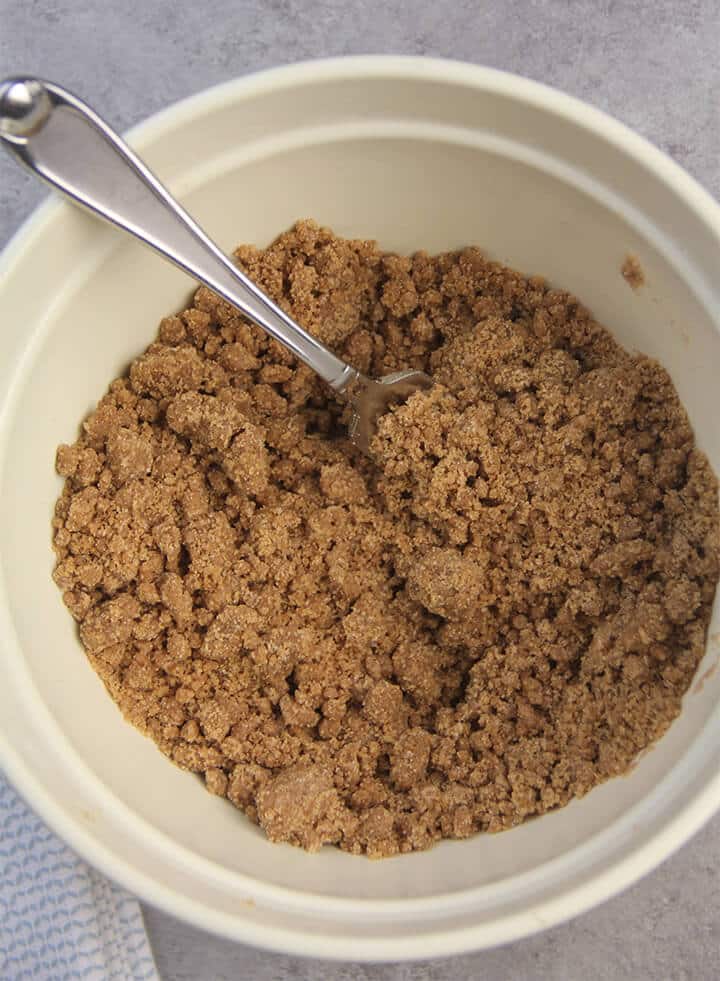 Brown sugar streusel mixed in a bowl with a fork.