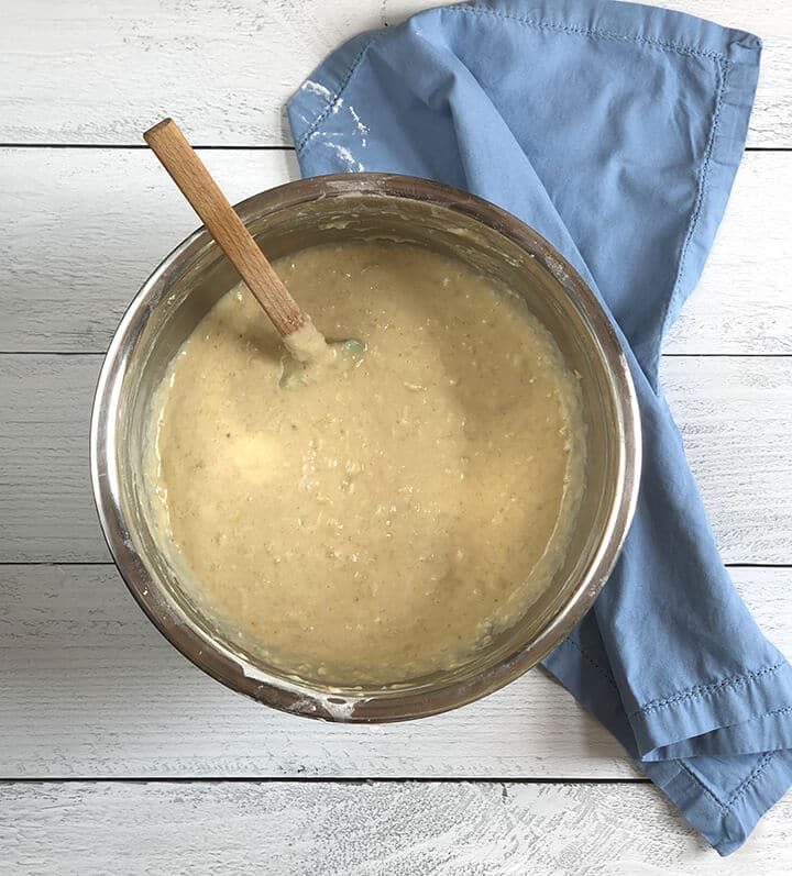 Batter for banana bread in a stainless bowl.