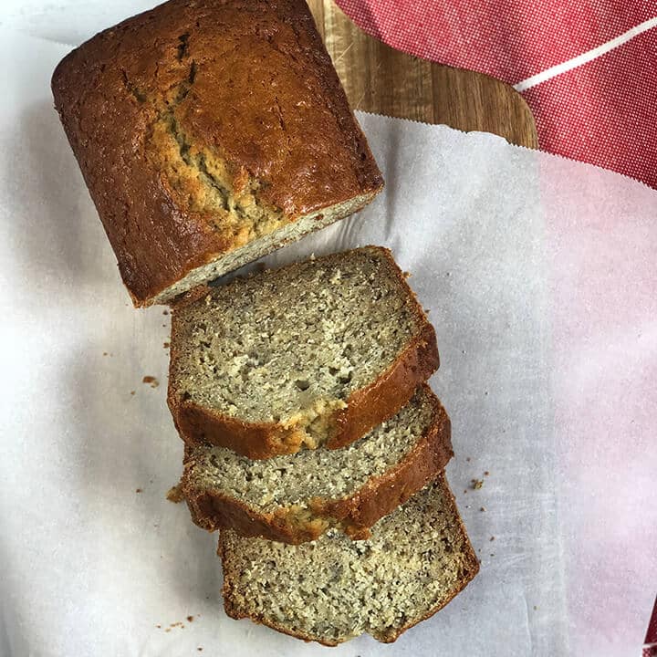 Old fashioned banana bread on wax paper sliced.