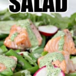 Spring salad recipe bursting with fresh vegetables like asparagus, edamame, sugar snap peas, arugula, radishes, and more—topped with easy baked salmon and drizzled with homemade Green Goddess Dressing. It's fresh, beautiful, and healthy!
