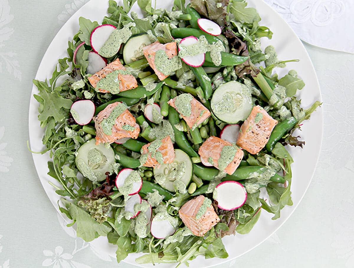 A lovely salmon and spring vegetable salad with crisp asparagus, sugar snap peas, edamame, radishes