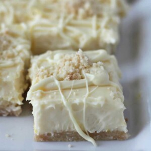 An image of white chocolate cheesecake bars on a platter.