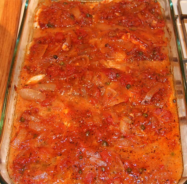 A baking dish with Mediterranean baked fish.