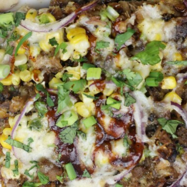 BBQ Pork Pizza with Roasted Corn, Jalapeno, and Smoked Mozzarella is super easy using pre-cooked bbq pork. This BBQ Pork Pizza pops with flavor and is a great addition to a weekly meal plan.