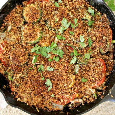 Summer vegetables roasted in a cast iron skillet with toasted breadcrumbs.