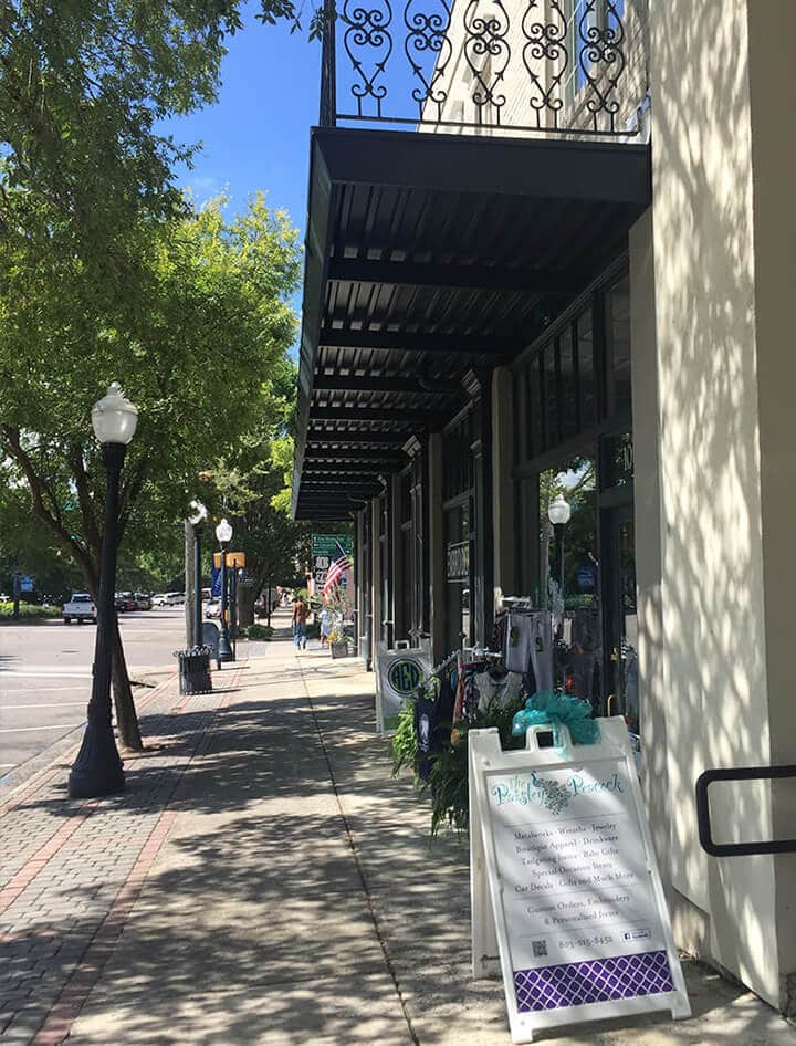 View of a street with shops and street lamps in downtown Aiken, SC.