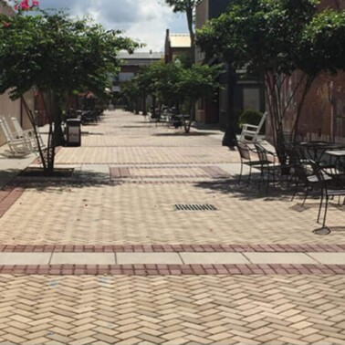 A brick-lined alley with tables and chairs in downtown Aiken, SC.