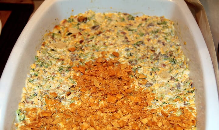 Side view of unbaked broccoli casserole covered with cheese crackers.