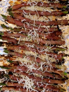 Prosciutto wrapped asparagus crispy from the grill and sprinkled with Parmesan cheese is one of our favorite and easiest appetizers!